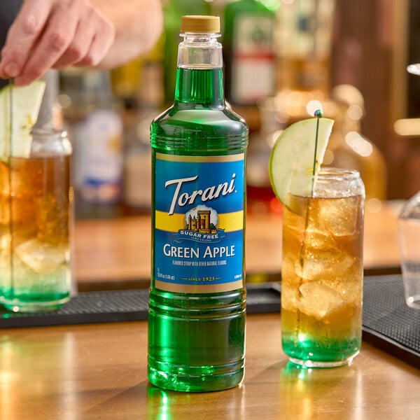 A 1-liter plastic bottle of Torani Sugar-Free Green Apple flavoring syrup.