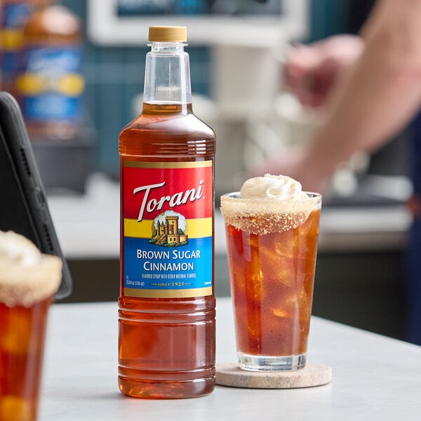 A 1-liter plastic bottle of Torani Brown Sugar Cinnamon flavoring syrup.