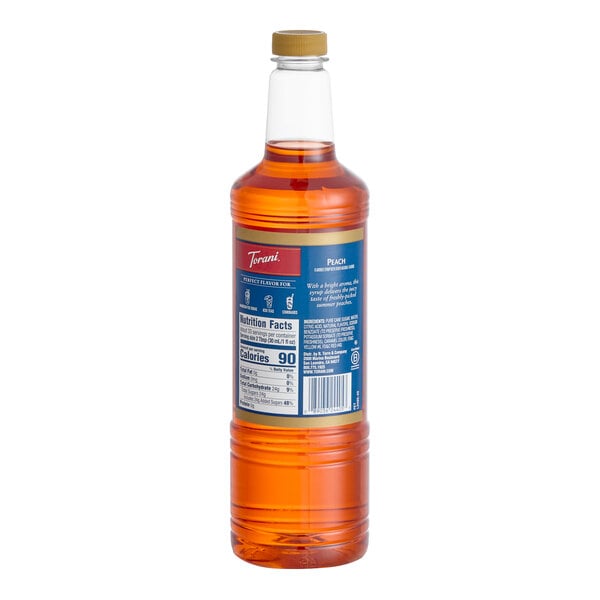 A 1-liter plastic bottle of Torani Peach flavoring and fruit syrup.