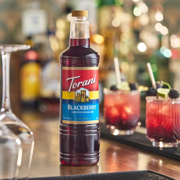 A 1-liter plastic bottle of Torani Blackberry flavoring and fruit syrup.