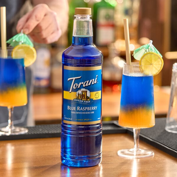 A 1-liter plastic bottle of Torani Sugar-Free Blue Raspberry flavoring syrup.