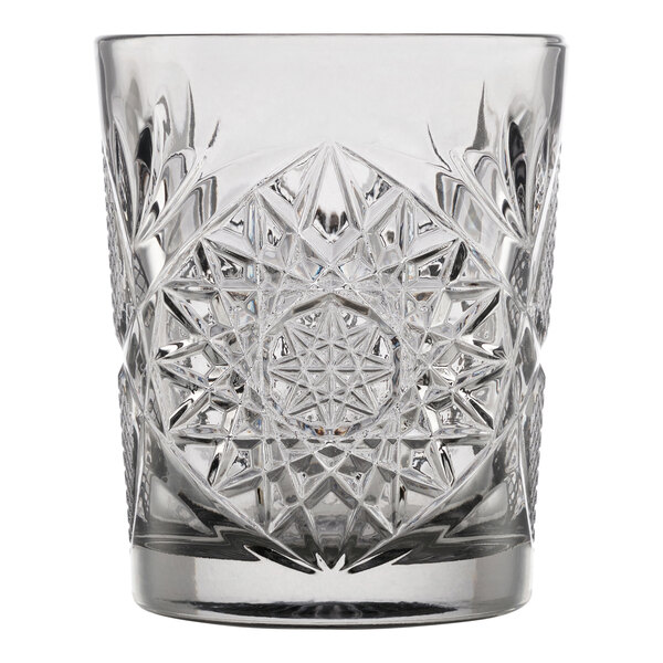 A clear glass with an intricate, starburst cut pattern, designed for serving rocks or double old fashioned drinks.