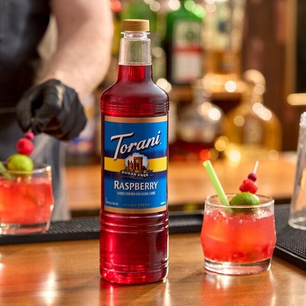 A 1-liter plastic bottle of Torani Sugar-Free Raspberry flavoring syrup.