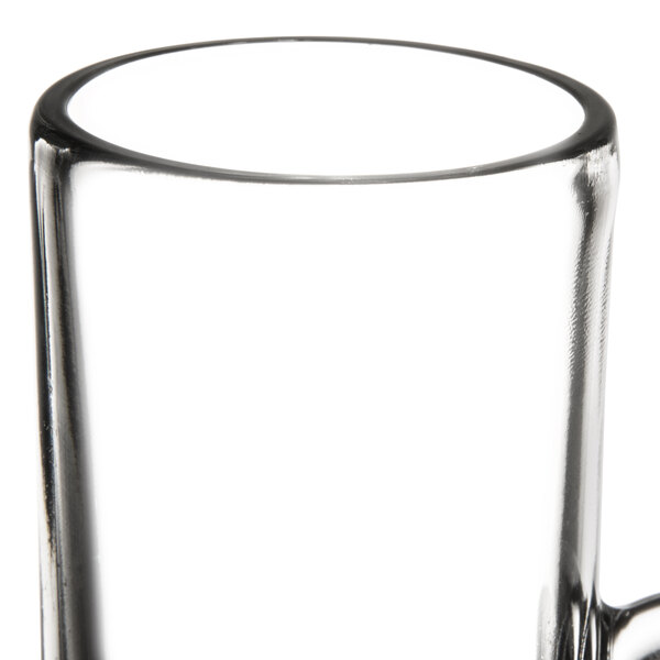 A clear glass coffee mug with a handle.