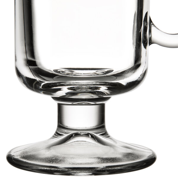 An 8 oz. clear glass Irish coffee mug with a sturdy base and handle.