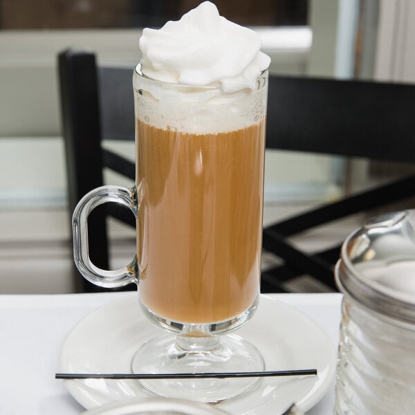 An 8 oz. glass Irish coffee mug filled with coffee and topped with whipped cream.