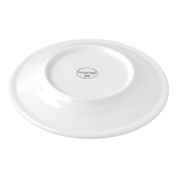 A white porcelain plate shown upside down with a manufacturer's mark in the center.