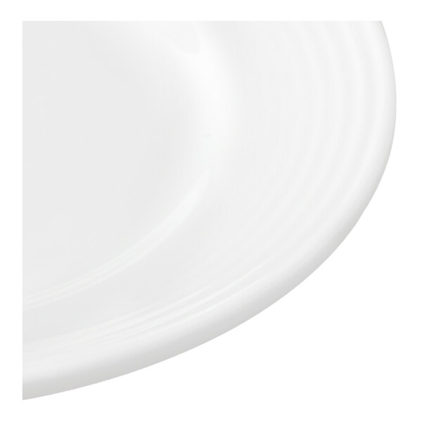 A white porcelain plate with a subtle ridged pattern along the rim.