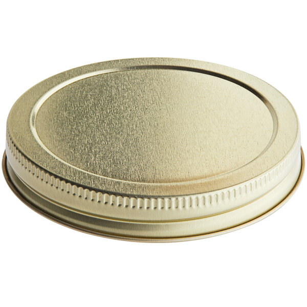 A gold metal jar lid with a plastisol liner.