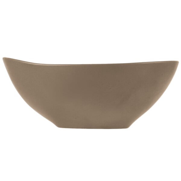 A matte sand-colored porcelain bowl with an organic, curved shape.