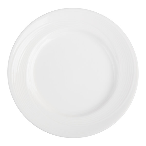 A plain white round plate with a wide rim and subtle concentric circular patterns.