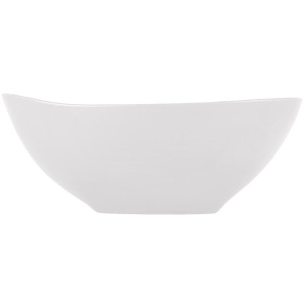 A white satin matte porcelain bowl with an organic, slightly curved shape.