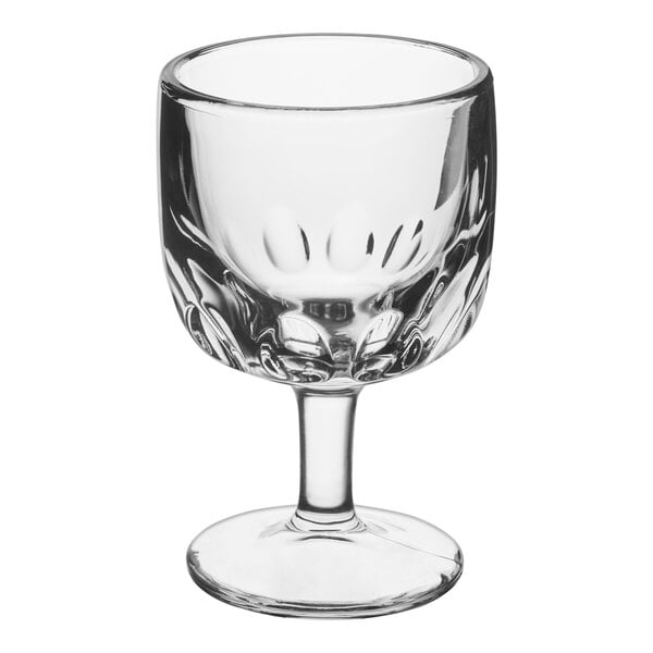 A clear glass schooner with a short stem and a wide, rounded bowl.