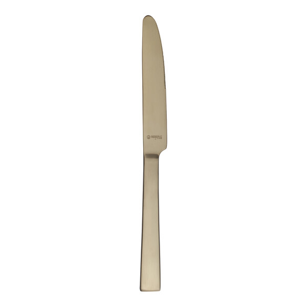 A gold-colored stainless steel dinner knife with a straight handle and a slightly serrated edge.