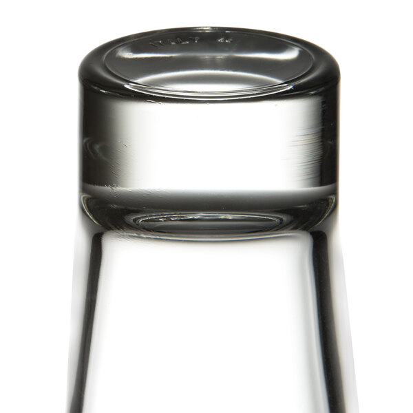 A clear, upside-down highball glass with a thick base.