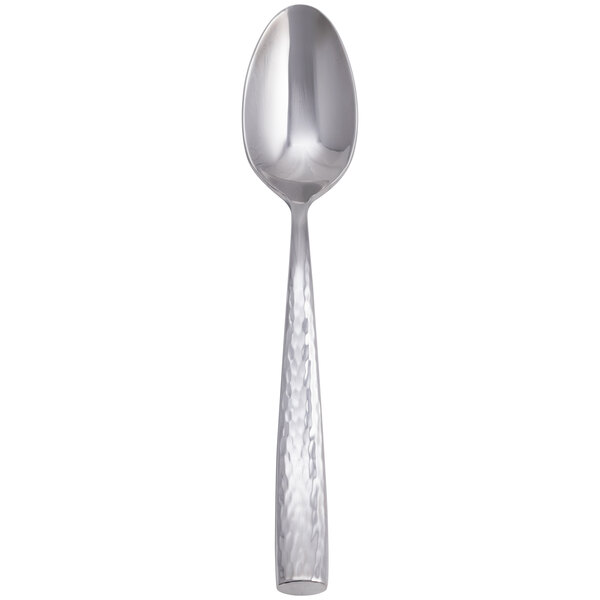 A stainless steel teaspoon with a textured handle.