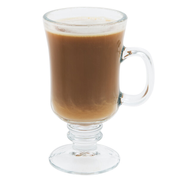 An 8.5 oz. clear glass Irish coffee mug with a handle and pedestal base.