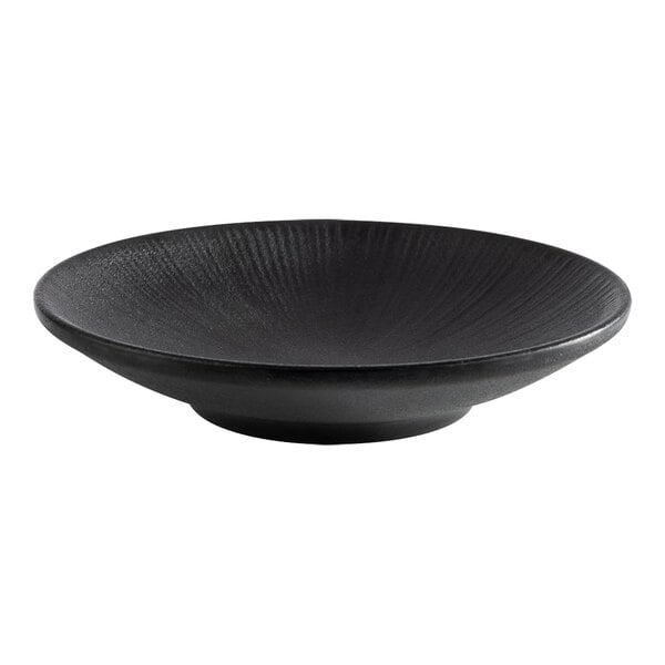 A black round coupe melamine plate with a textured surface.
