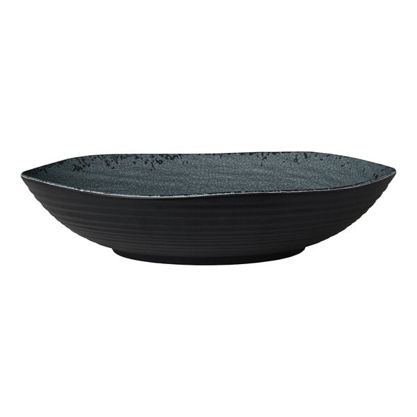 A round, shallow, slate-colored melamine bowl with a textured interior.