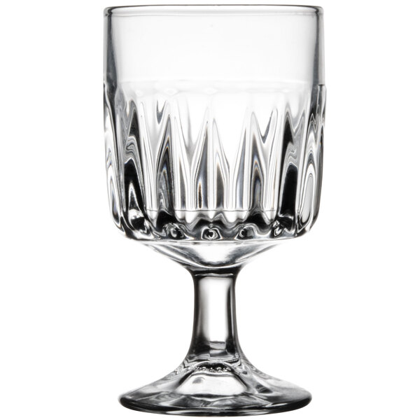 A clear glass goblet with a textured design and a sturdy stem.