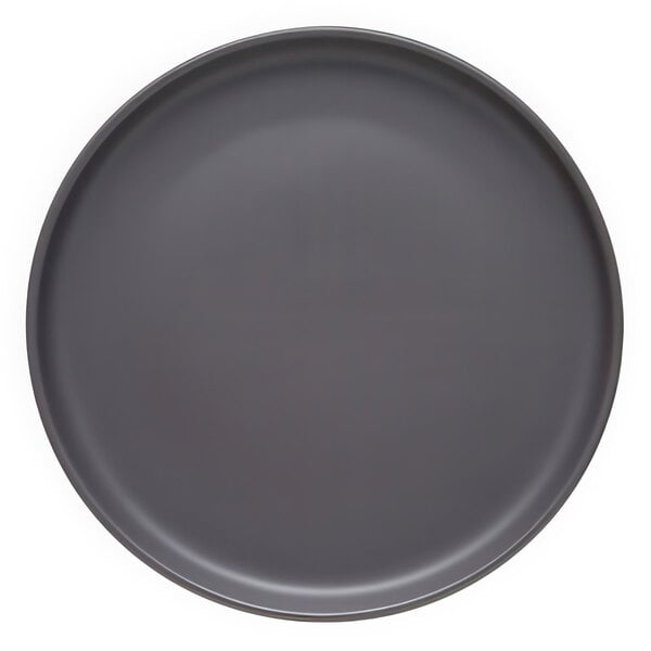 A round, matte granite-colored porcelain coupe plate.
