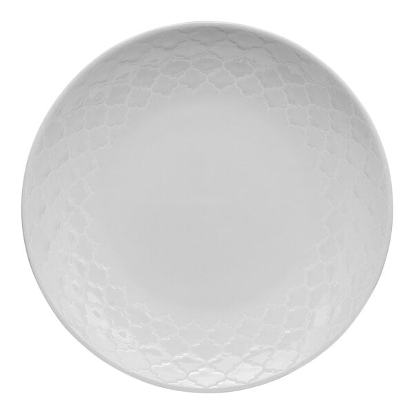 A white porcelain plate with a subtle geometric pattern around the rim.