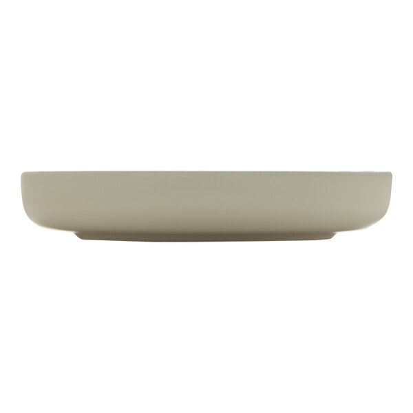 A beige porcelain deep raised rim plate.