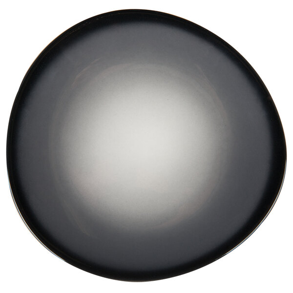 A round, dark gray porcelain plate with a smooth, organic shape and a gradient finish.