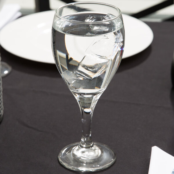 A clear Libbey Teardrop 12 oz. goblet filled with ice water.
