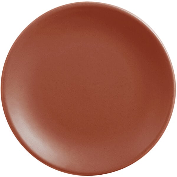 A round, clay-colored satin matte porcelain coupe plate.