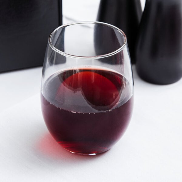 A clear Libbey 15 oz. stemless wine glass partially filled with red wine.