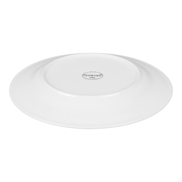 A white porcelain plate shown upside down with a visible logo at the center.