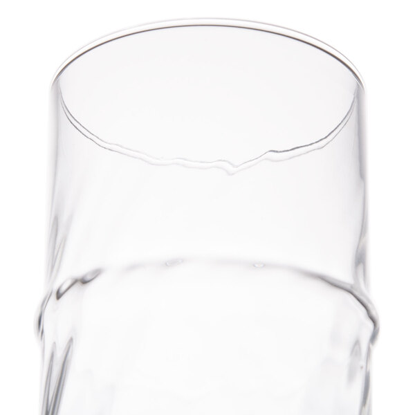 A clear 16 oz. specialty cooler glass with a slightly irregular rim.
