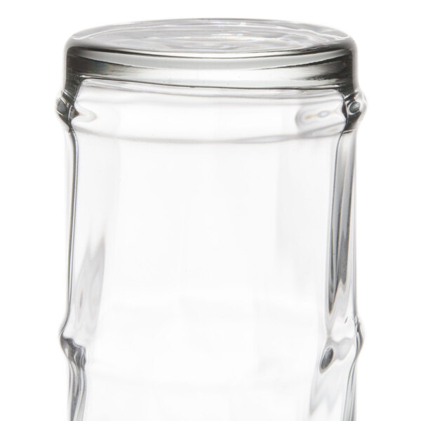 A clear 16 oz. specialty cooler glass with a slightly contoured shape.