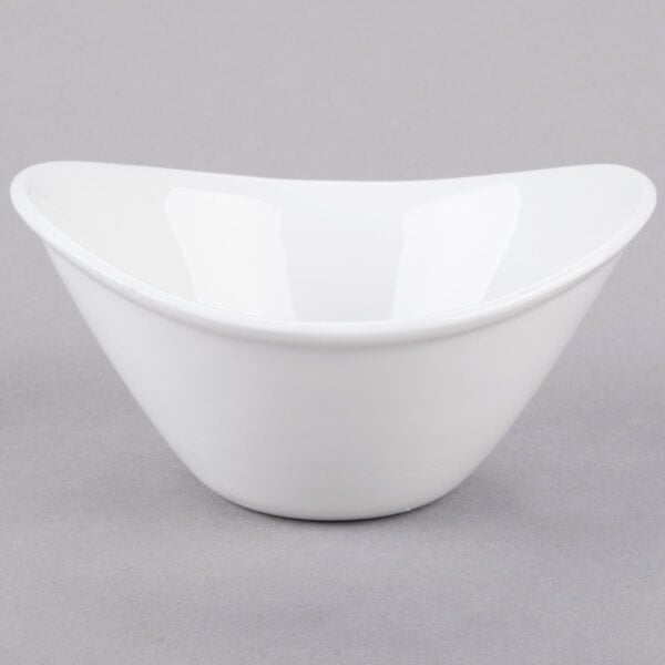 A small, bright white oval porcelain bowl.