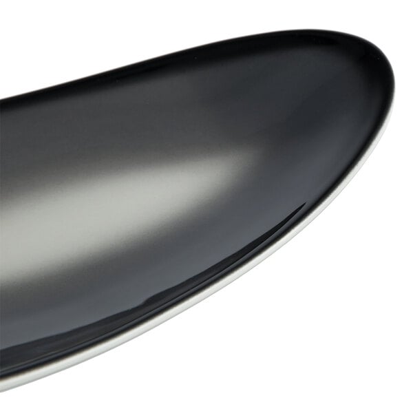 A black and gray oval porcelain tray with a smooth, glossy finish.