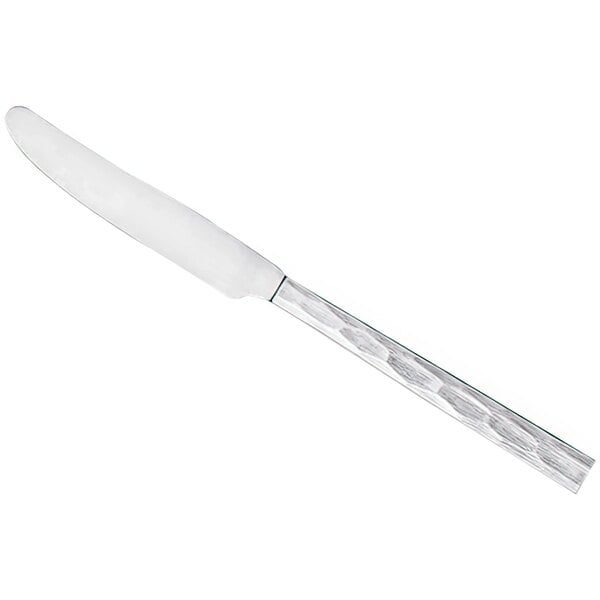 A stainless steel dinner knife with a textured handle and a smooth blade.