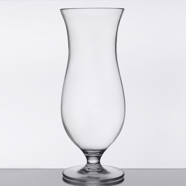 A clear 16 oz. Tritan plastic hurricane glass with a curved bowl and sturdy base.