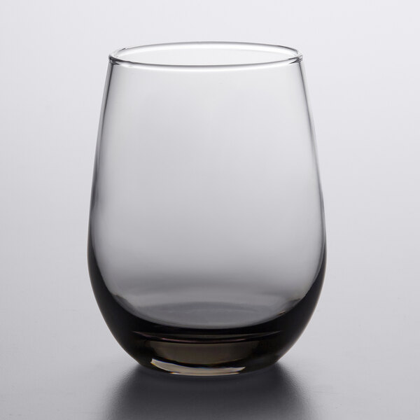 A clear, stemless white wine glass with a subtle moonstone grey tint.