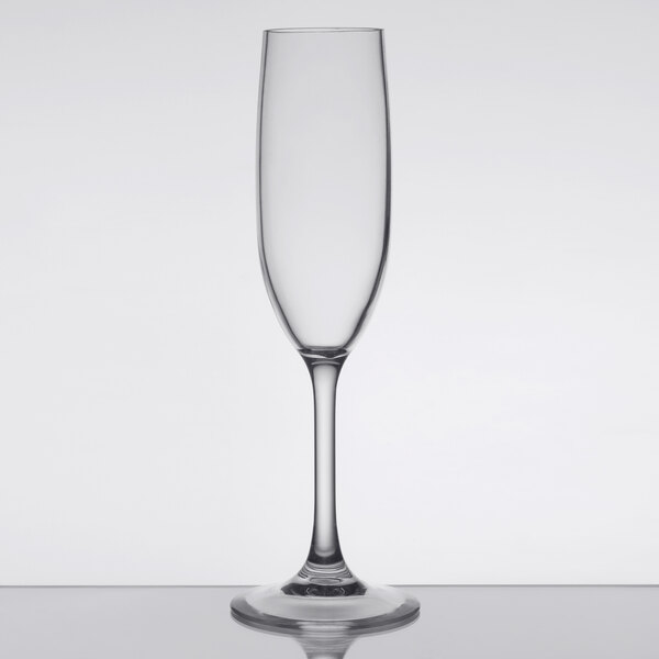 A clear plastic champagne flute with a tall, slender bowl and a long stem.