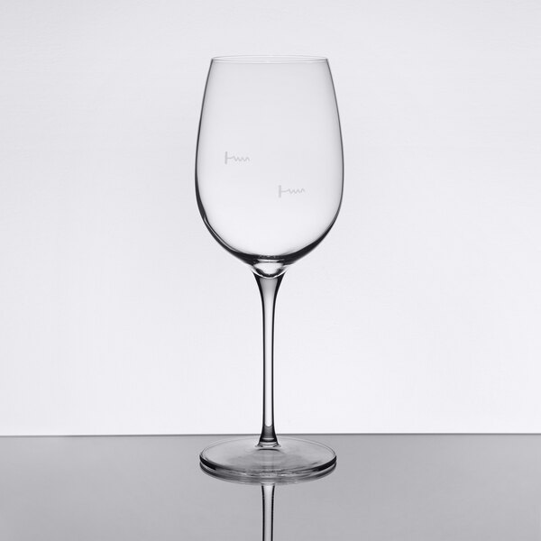 A clear stemmed wine glass with pour control markings for 8 oz. and 5 oz. measurements.