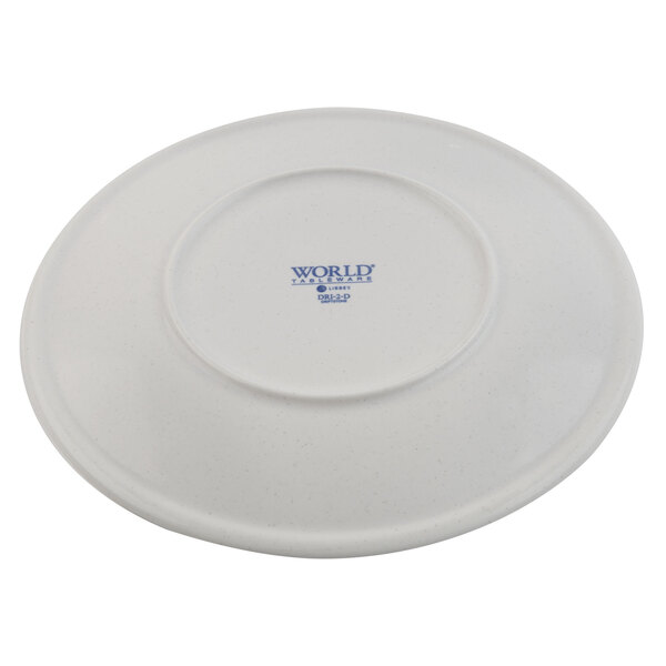 A white porcelain coupe plate shown upside down with a manufacturer's mark on the bottom.