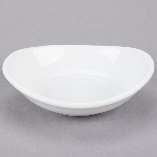 A small, bright white oval porcelain bowl.