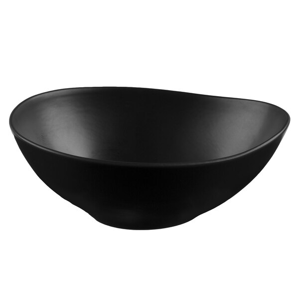 A black matte porcelain bowl with an organic, asymmetrical shape.