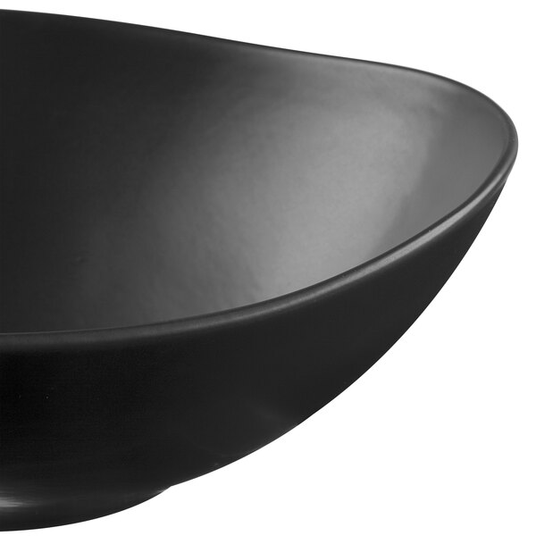 A black satin matte porcelain bowl with an organic shape.
