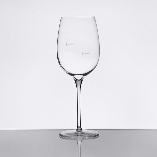A clear stemmed wine glass with pour control markings for 9 oz. and 6 oz. measurements.