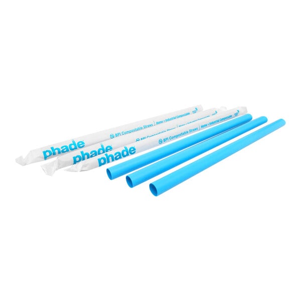 A set of blue compostable straws, some individually wrapped in white paper labeled 'phade.'