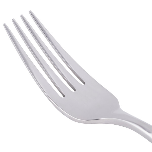 A stainless steel dinner fork with four tines.