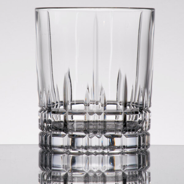 A clear Spiegelau Perfect Serve 12.5 oz. rocks or double old fashioned glass with a faceted design near the base.