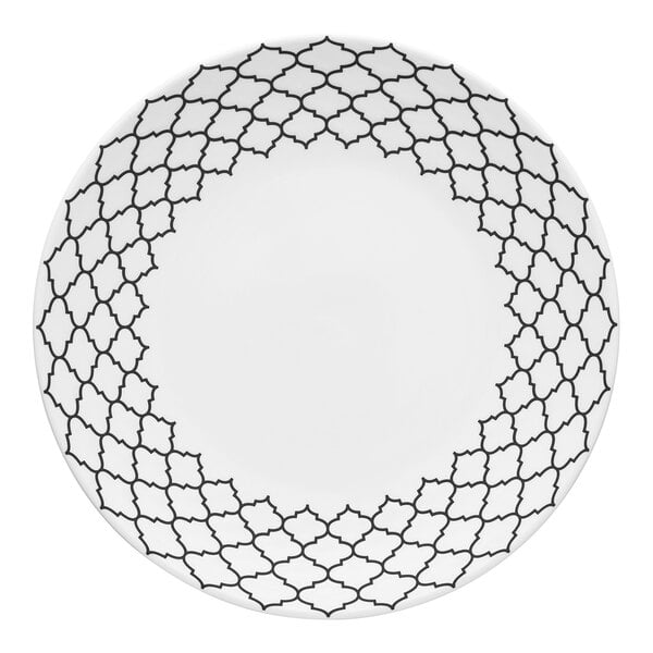 A white porcelain plate with black geometric embossing around the rim.